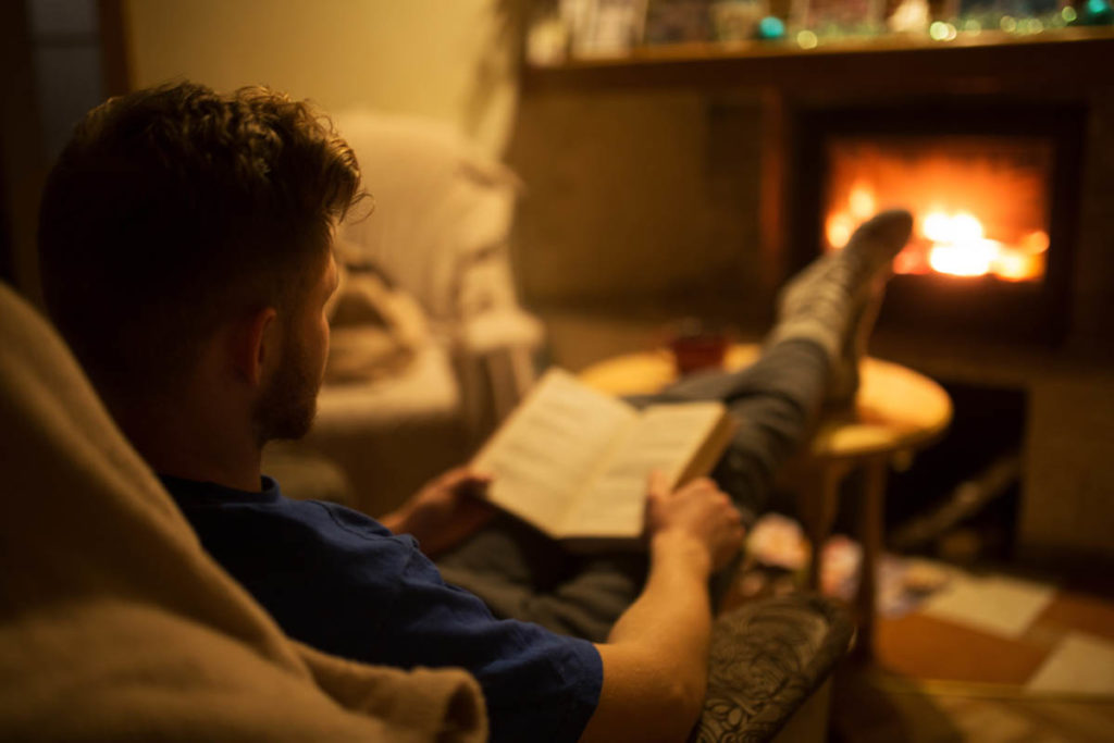 a man works hard to stay sober during the holidays in front of a cozy fire