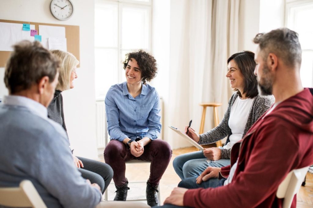 people discuss the benefits of their medication assisted treatment in group therapy for addiction recovery