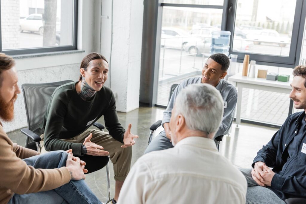 a therapy group meets for a session within a mens rehab program