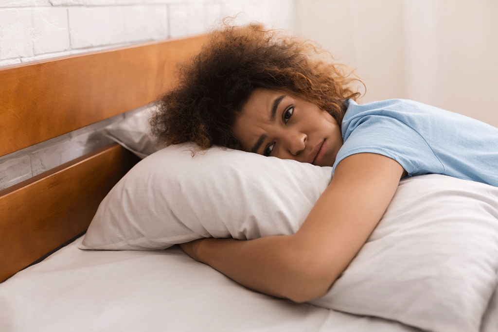 a woman struggles to sleep due to unresolved childhood trauma