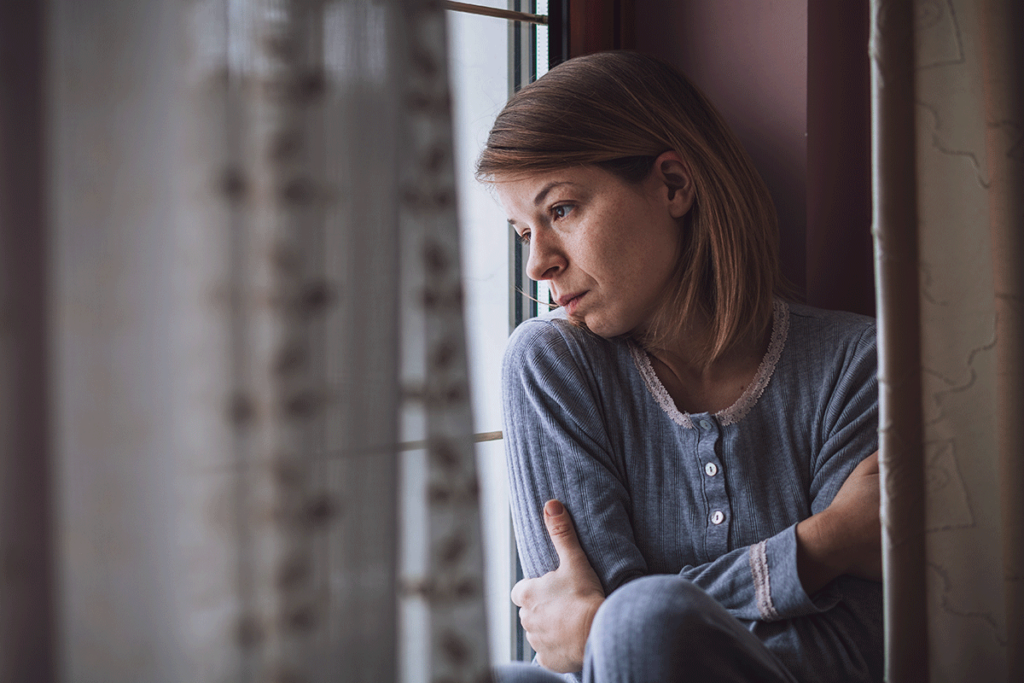 a woman struggles through her alcohol withdrawal symptoms